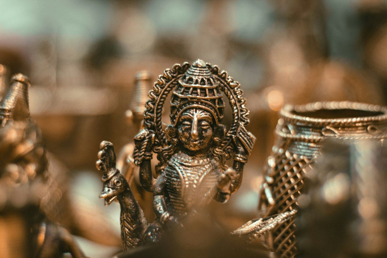 Close-up of a bronze deity figure with aged patina