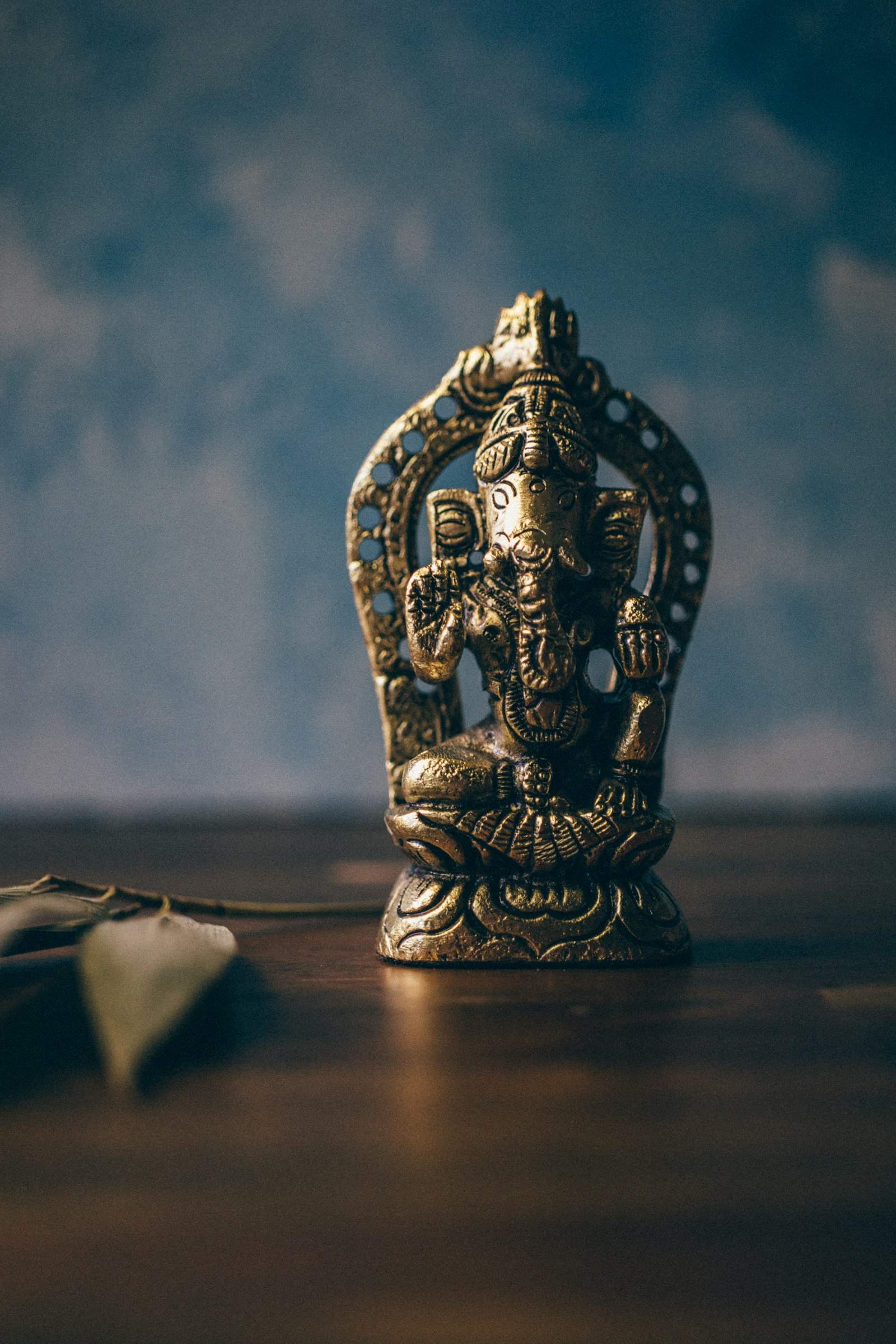 Aged brass Ganesha statue on a wooden table