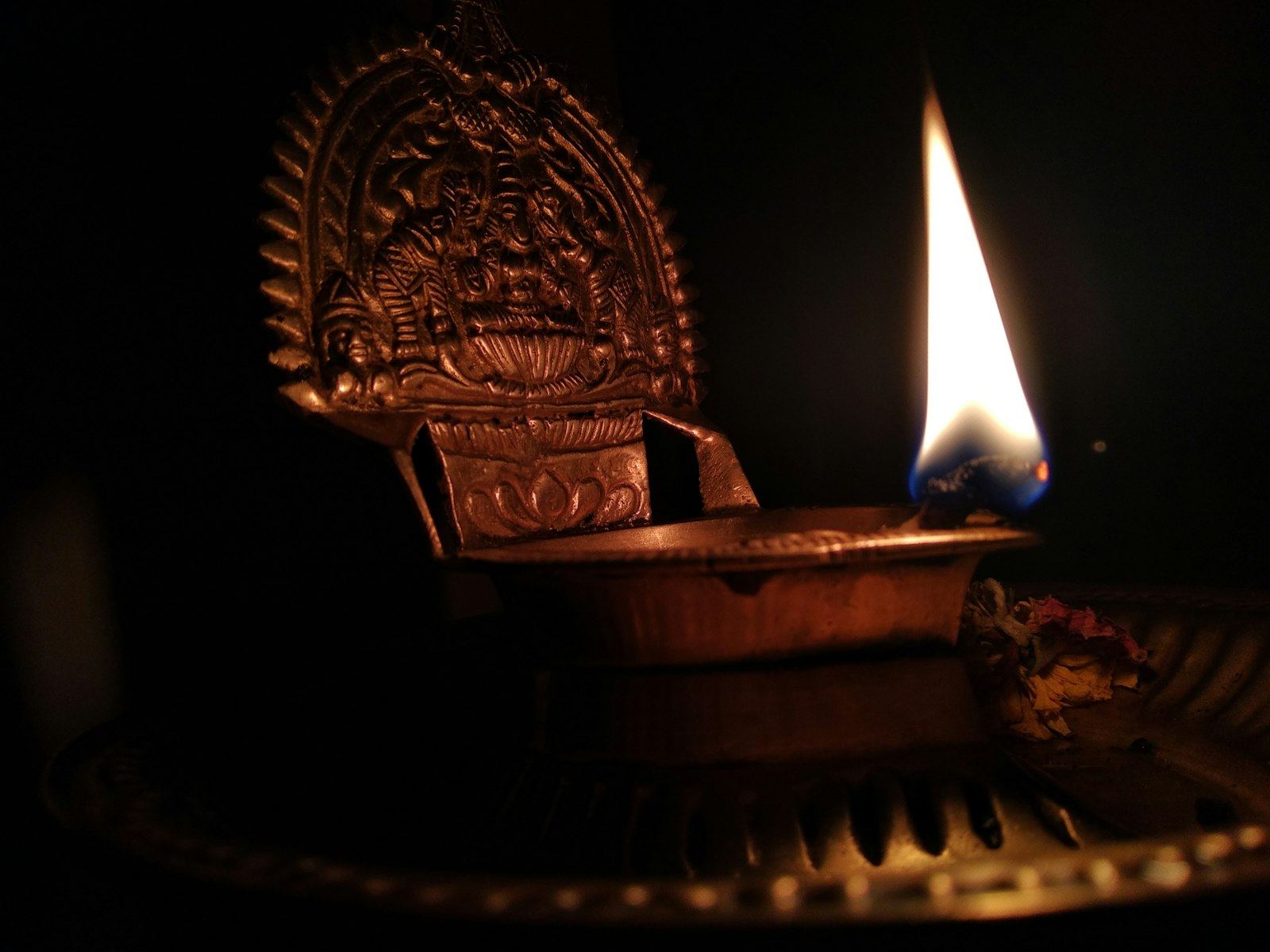 Ornate brass oil lamp with a single flame