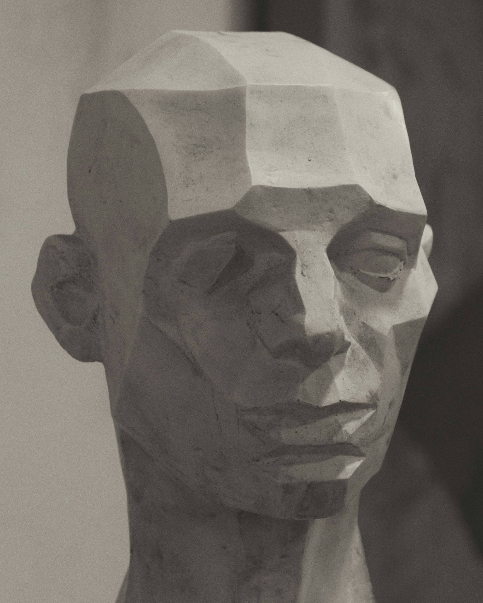 Carved stone portrait bust in soft light