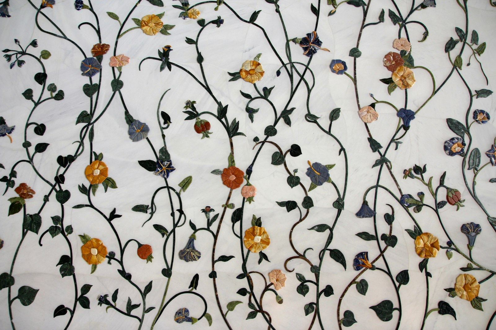 Floral semi-precious stone inlay in white marble